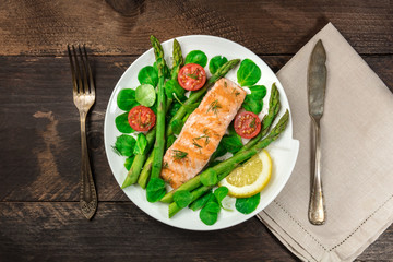 Grilled salmon with asparagus, green salad, and copyspace