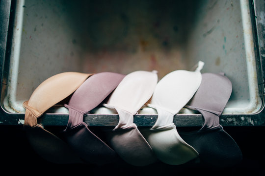several bras drying on a laundry sink