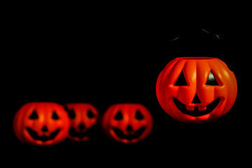 Horror or scary pumpkin (put on the floor and hanging) for Halloween Day concept, space for your content and isolated on black background.
