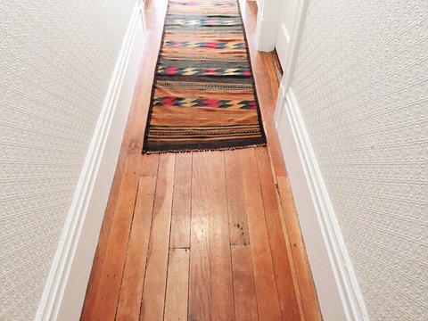 Aztec Patterned Rug Hallway Runner On Hardwood Floor In Bright White Wall Hallway