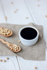 soybean sauce in a white ceramic bowl on piece of cloth