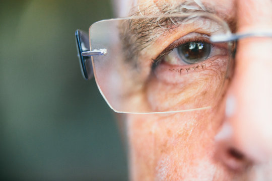 Senior man close-up shot of his eye wearing viewing glasses