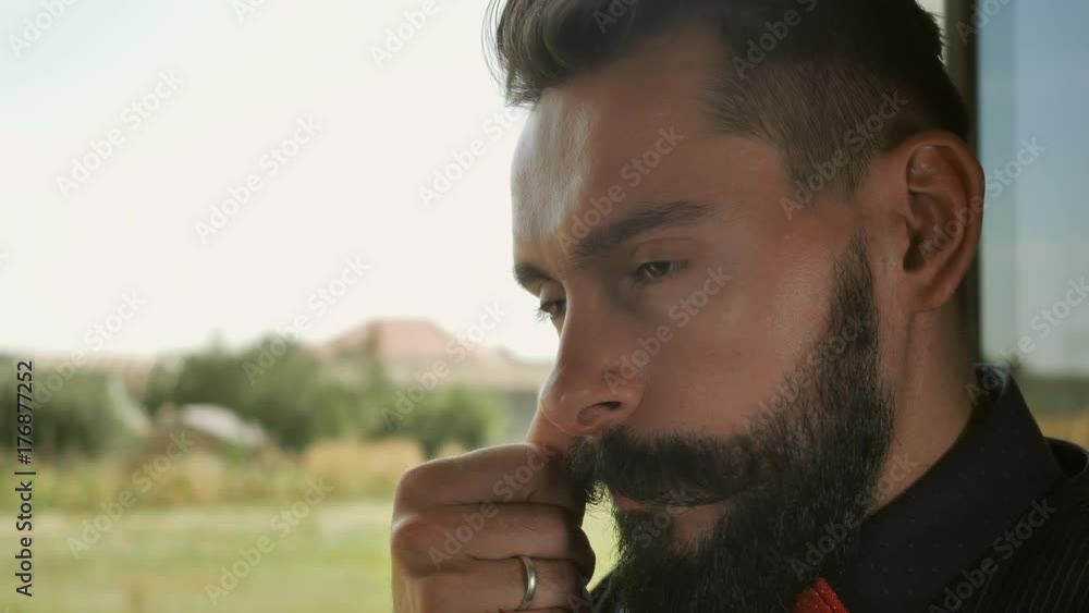 Poster married guy with beard and mustache.handsome hipster man posing looking at the camera winking. portr
