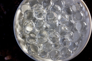 Hydrogel balls on white bowl.