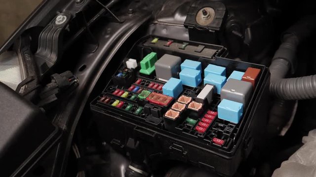 Looking at the fuse box of a car.