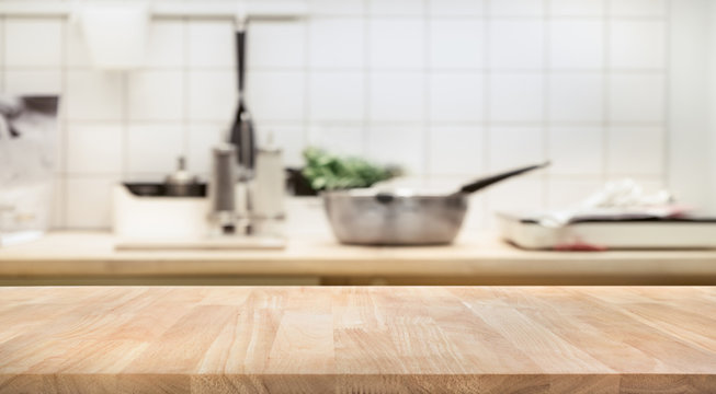 Wood table top on blur kitchen room background .For montage product display or  key visual layout.