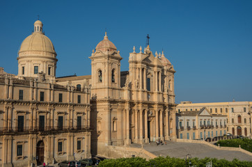 Fototapeta na wymiar The famous baroque cathedral of Noto in sunset. View from belltower of St. Charles Church. Sicily, Italy