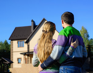 Loving couple looking at their dream house. copy space