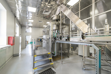 Distillery. Line for filling and capping bottles.