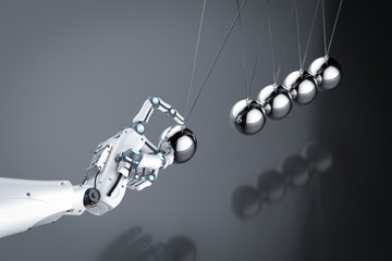 robot hand holding newton cradle