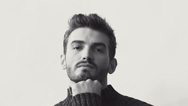 Passionate look at camera of handsome man in pose. Black and white. Slowly