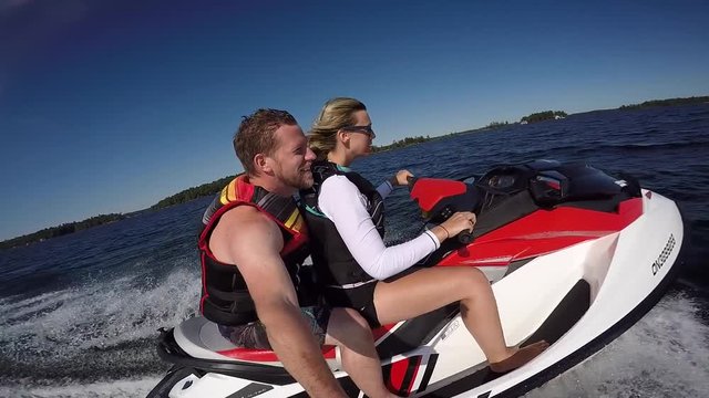 seadoo girl driving while guy takes selfie slow motion side angle