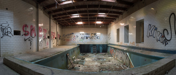 Panorama of interior of abandoned building with swimming pool