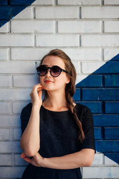 Young woman portrait against the wall