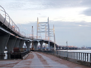 Cable-stayed bridge over the big river in the evening