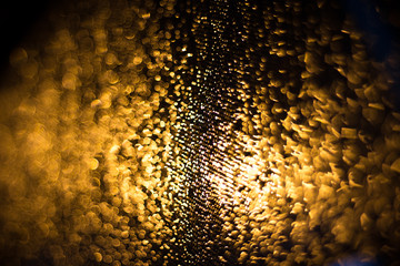 Abstract blur background of gold lighting during raining