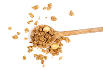 Crunchy granola, muesli pile in metal spoon with nuts isolated on white background, top view