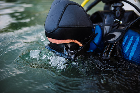 Diver in swimming mask looking underwater