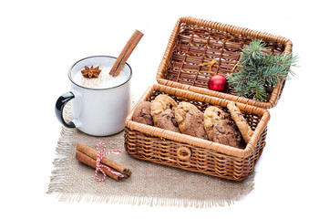 eggnog cocktail in red mug arranged with christmas decoration and cookies box isolated on white
