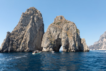 Fototapeta na wymiar Faraglioni Rocks on Capri Island, Italy. Rock's names left to left: Stella, Mezzo and Scopolo or Fuori