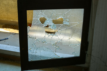 The broken glass door in an old ruined hotel.