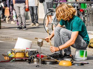 percussionist use pots and pans to play drums - busker street artist musician.