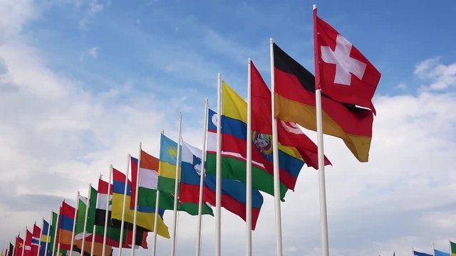 Many flags of different countries waving