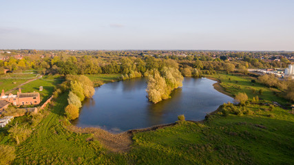 Fototapeta na wymiar Aerial view over a lake in a park in the countryside