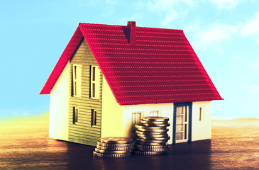 Miniature house with coins
