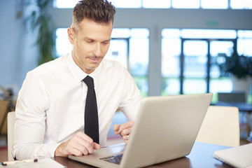 Businessman working on new project on laptop at office