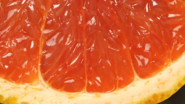 ripe grapefruit. Red color citrus fruit, rotates around the axis. Macro, studio light, advertising semk.