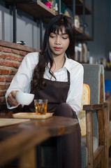 Barista prepares cappuccino in his coffee shop.,Asian woman working in coffee shop cafe barista concept