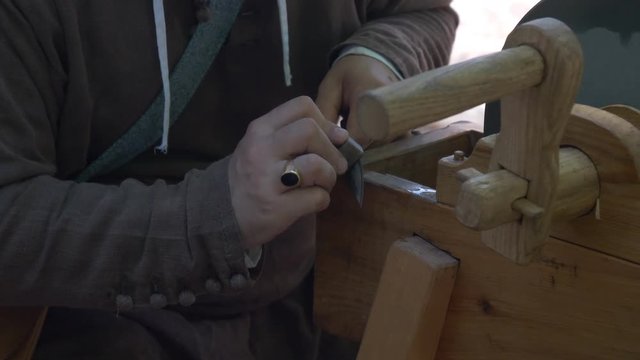 Close up of a craftsman working with leather during a middle ages reenacting