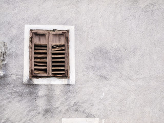 Old window with weathered shutters