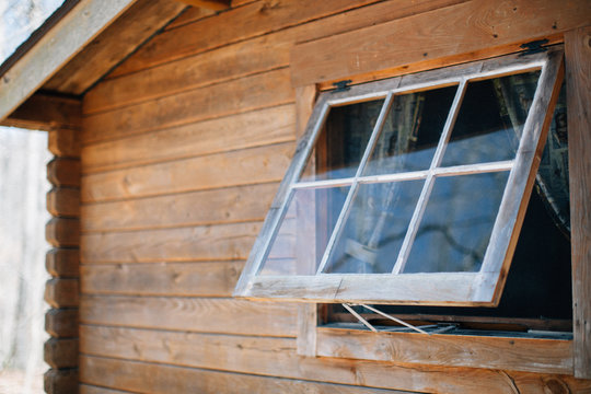 an open window of a wood cabin