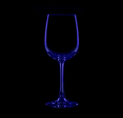 Silhouette of wineglass with blue and red illumination