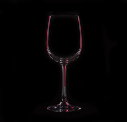 Silhouette of wineglass with red illumination