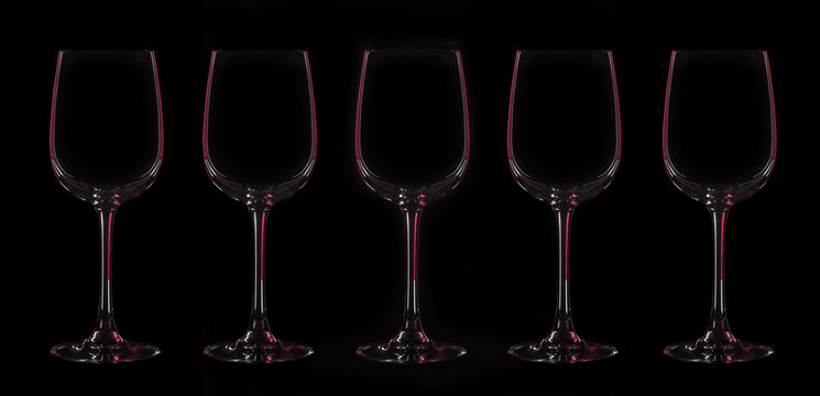 Silhouette of five wineglasses with red illumination