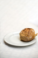 Naklejka premium Small Bread on White Plate, space for text