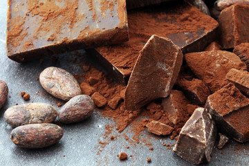 Raw cocoa beans, cocoa powder and chocolate pieces.