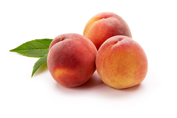 Peaches with leaf isolated on white background
