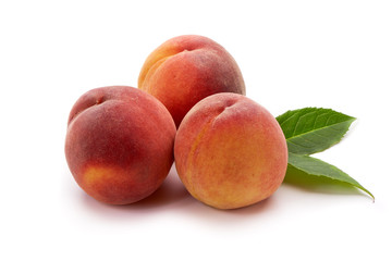 Peaches with leaf isolated on white background