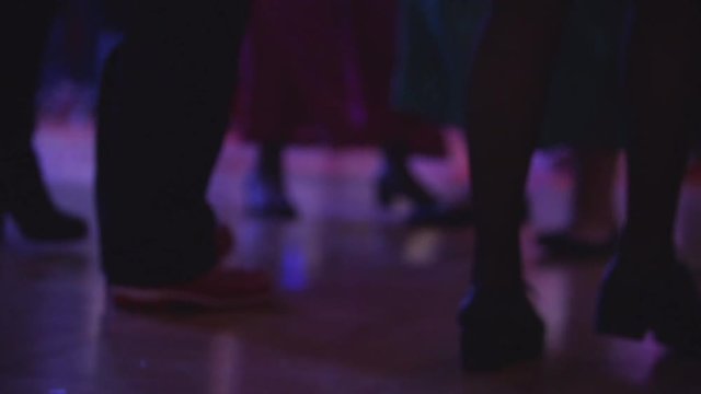Amazing bottom shot of boots dancing a line dancing at a party. People having fun at disco club. Entertainment industry, friday night and holidays concept.
