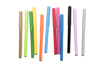 Colorful markers making forms on a white background