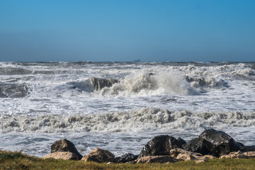 Stormy sea huge waves breaking near the coast