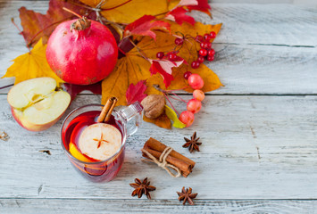 Mulled wine, grog in a glass with cinnamon and fruit, autumn decor and drink

