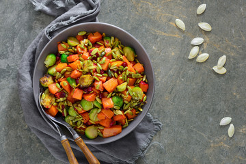 Butternut squash and brussels sprouts salad with cranberry and pumpkin seeds