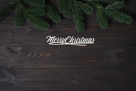 Christmas wooden background with fir tree.