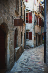 Fototapeta na wymiar Narrow streets of the ancient city-fortress of the Mediterranean. Travel to Montenegro, Kotor.