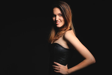 Girl in a black dress smiling 